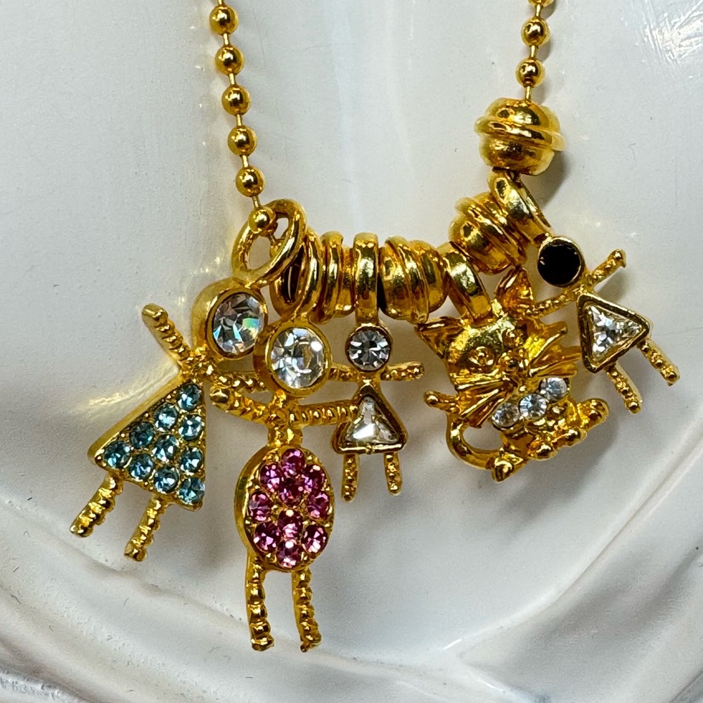 KISS Necklace -Gold Tone Multi-Charm Necklace with Blue and Pink Crystal Accents